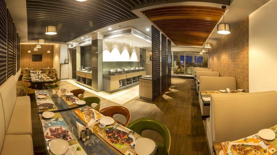 Mint N Mustard Restaurant at Mayberry Tiruppur showcasing a well-arranged dining area with modern decor and comfortable seating